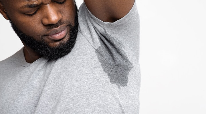 man looking at under arm sweat